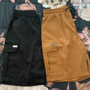 Two pair of never worn men’s cargo shorts. Black and Copper